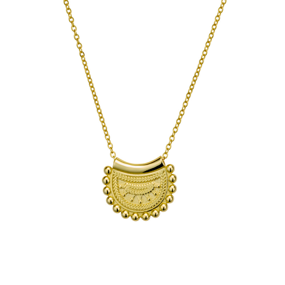 Gold necklace with a decorative pendant on a white background